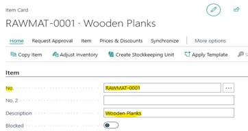 A screenshot of a Microsoft Dynamics 365 Business Central Item Card for 'Wooden Planks,' showing the automatically assigned number 'RAWMAT-0001' based on the previously configured number series.