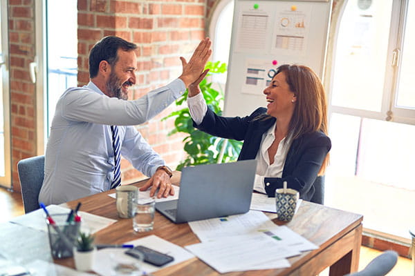 Consultants reviewing a Microsoft Copilot rollout plan together in an office