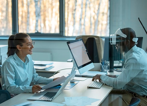 Smiling professionals discussing on how application modernization with AI transforms outdated applications into agile, future-ready assets.